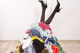 women tripping over cluttered clothes
