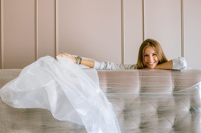 a woman unpacking a couch