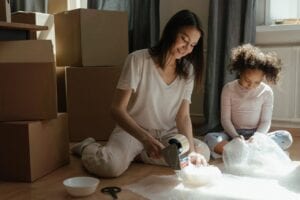 A woman and a girl who want to stay organized during a move by packing essentials last