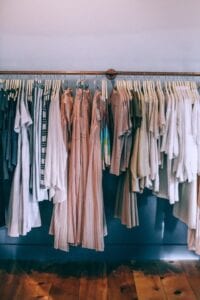a collection of clothes on a rack, one of the mistakes people make when organizing their homes