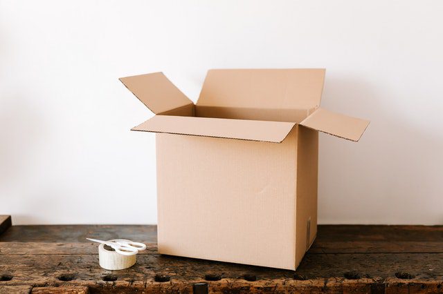 a cardboard box for decluttering and organizing your self-storage