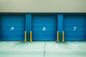 Three storage units marked by numbers with blue doors