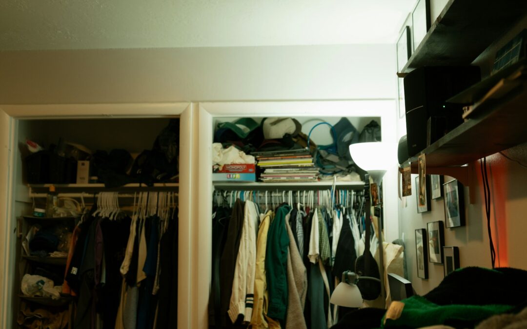 Full household closet with clothing and items stored above the hanging rod
