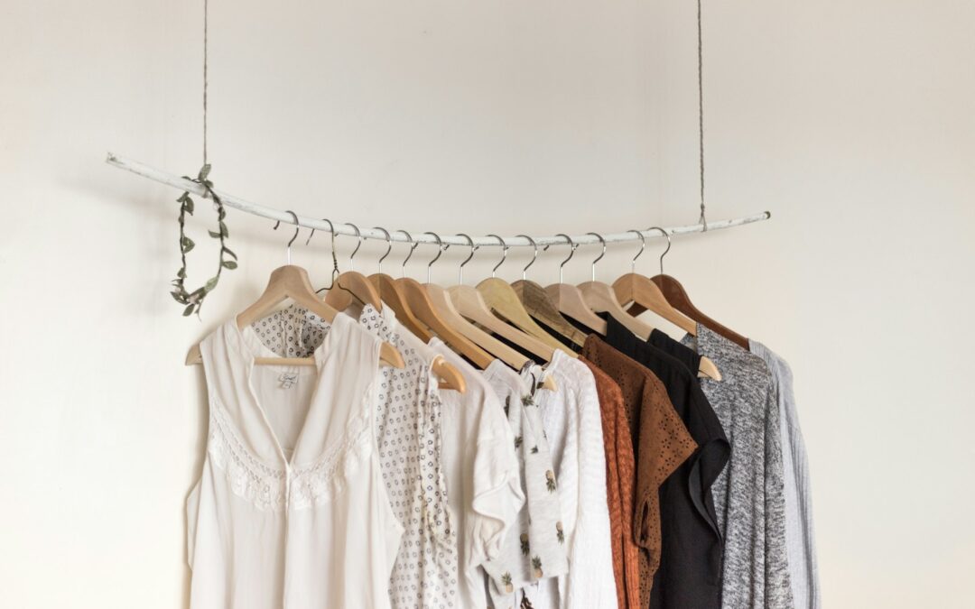 Small collection of neutral clothing on wooden hangers