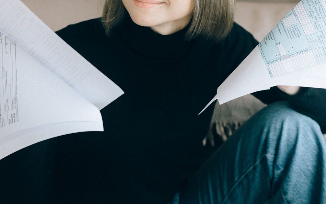 Woman sorting paperwork and documents at a desk